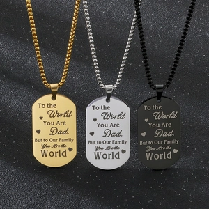 Detailed view of three stainless steel dog tag necklaces in gold, silver and black finish