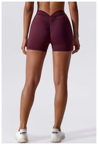 Detail of high-waist scrunch butt yoga shorts in burgundy with V-shape waistband