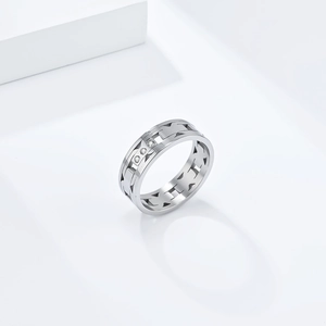 Macro detail of silver titanium steel ring with geometric cut-outs and small crystals