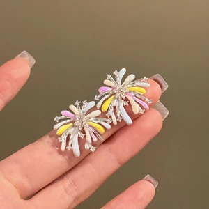 Macro detail of firework studs with colorful enamel and inlaid zircon accents