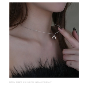 Close-up of S925 sterling silver Mobius loop pendant necklace on a female neck