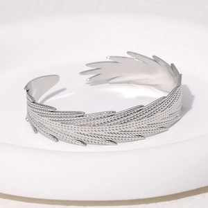 Polished silver stainless steel feather open bangle with detailed metallic leaf texture