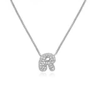 Detail shot of silver letter R pendant with micro-paved zircons on a box chain
