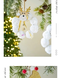 Close-up of plush white reindeer wreath with gold glitter hat and small metal bells