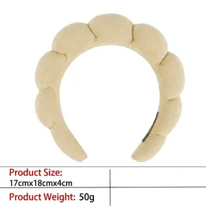 Detail of beige sponge cloud headband featuring soft terry cloth and padded wave design