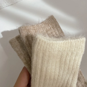 Thick wool socks for women in beige and oatmeal tones with cozy knitted texture