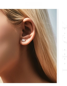 Close-up of elegant emerald-cut rectangular stud earring worn on a model's ear