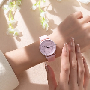 Pink minimalist quartz watch with silicone strap and numeric dial shown on wrist