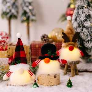Three Christmas glowing gnomes with plaid hats and reindeer horns on snow background