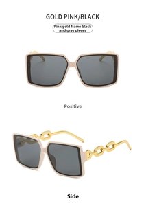 Detail of pink gold square oversized sunglasses featuring chic metal chain temple design