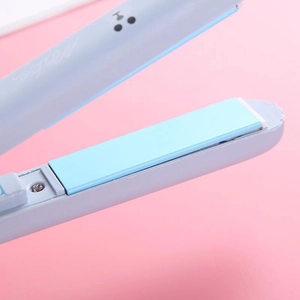 Mini ceramic hair straightener in baby blue color for portable styling and smooth hair