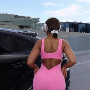 Pink backless yoga jumpsuit with flattering ruched detail and cut-out cross back design