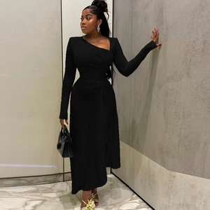 Close-up of the elegant waist ruching and asymmetric neckline on this black long dress