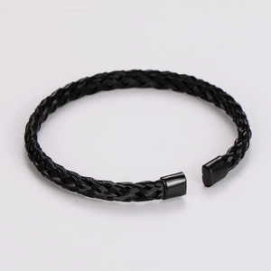 Close-up of black woven cable open cuff bracelet with polished stainless steel end caps
