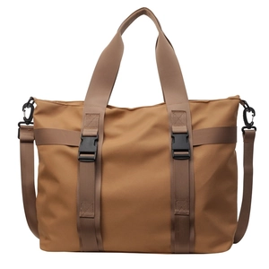Brown canvas tote bag with top handles and adjustable shoulder strap for daily casual use