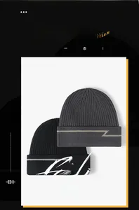 Close-up of thick knitted beanies in grey and black with geometric pattern weave