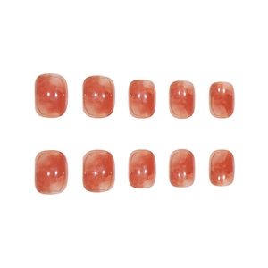 Short square amber marble nails with coral tones and elegant gold-edged detailing