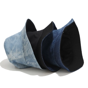 Three washed denim bucket hats in light blue, dark blue, and black for sun protection