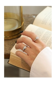 Macro view of vintage silver rings featuring celestial star and sun engravings on the band