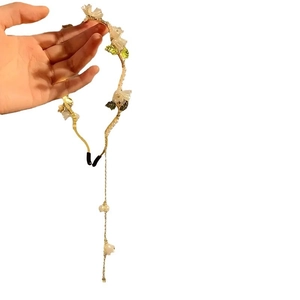 Elegant lily of the valley headband with pearl tassels on a gold metal frame