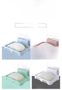 Detail of wall-mounted soap dishes with drainage grid in four Nordic pastel colors