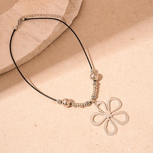 Detailed macro view of a silver hollow flower pendant with premium metallic finish and beads