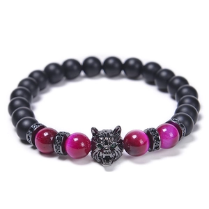 Detailed shot of wolf head bracelet with tiger eye stones and matte black beads