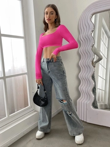 Detail of hot pink long sleeve crop top featuring a square neckline and elastic fabric