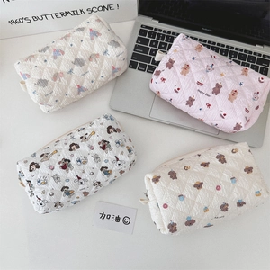 Detailed view of four quilted cotton pouches with bear and elephant cartoon patterns