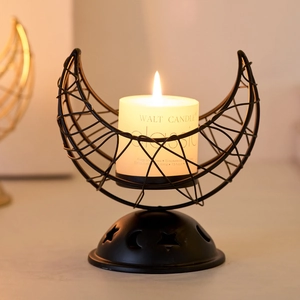 Matte black metal crescent moon candle holder with hollow star patterns for home decor