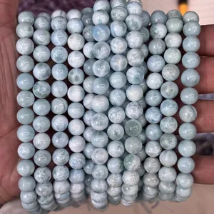 Macro shot of natural blue Larimar beads with distinctive sea-wave water patterns
