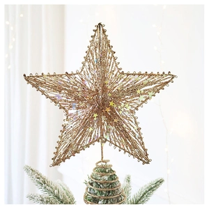 Detail of champagne gold glitter star topper with led lights on a festive Christmas tree