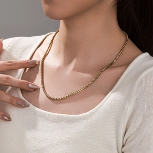 Classic 14k gold-plated Venetian box chain necklace worn on a female model's collarbone