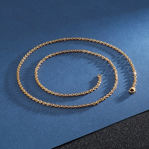Detailed view of a golden stainless steel cross chain with a secure lobster clasp