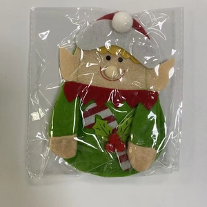 Detail of Christmas elf cutlery holder in felt fabric showing festive red and green colors
