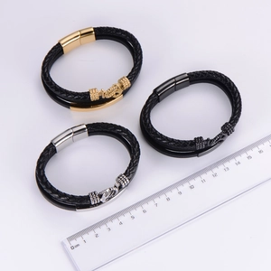 Detail showing woven leather bracelets with anchor magnetic clasps and a measurement scale