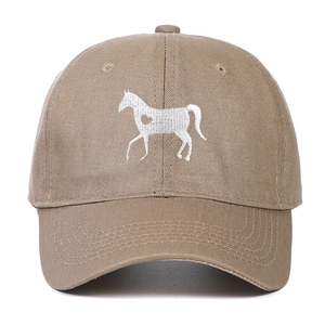 Close-up of heart horse embroidery on a khaki cotton baseball cap with white background