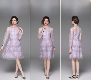 Detail of lavender purple lace dress featuring embroidery and tiered mesh long sleeves