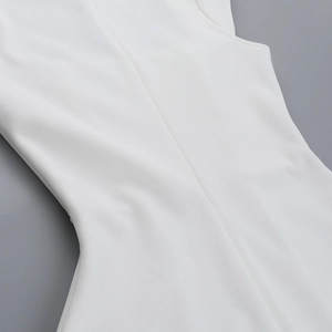 Detailed view of the tailored waistline and seam on a white minimalist sleeveless dress