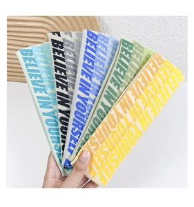 Set of five knitted athletic headbands in multiple colors featuring inspirational text