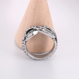 Detail of silver infinity ring with sparkling white zircons and textured band