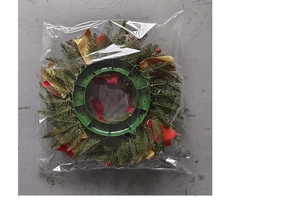 Detail of Christmas wreath with red berries and pine needles in storage packaging