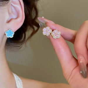 Close-up of elegant flower stud earrings with sparkling crystals and colorful petals