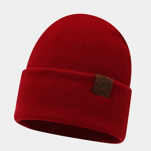 Detailed view of the dark red knit beanie featuring a premium embossed leather patch