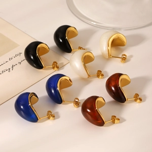 Macro detail of resin teardrop earrings in black, cream, blue, and amber with gold finish