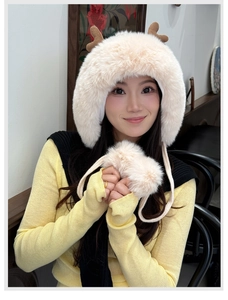 Detail of plush winter hat with reindeer antlers and pom-poms for cold protection