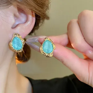 Retro geometric earrings with gold hammered texture and turquoise green drop stones