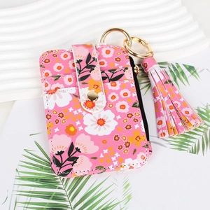 Pink floral card holder with golden keychain and decorative pink tassel detail