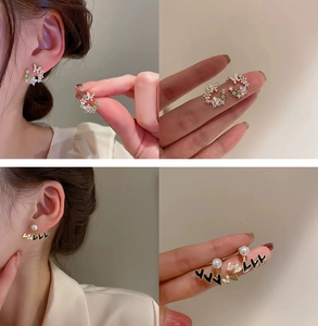 Detail of floral zircon studs and pearl heart earrings with gold plating and silver pins