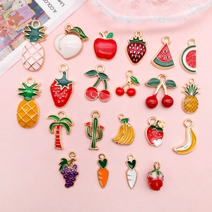 Detailed flat lay of twenty mixed enamel fruit charms including strawberry and pineapple